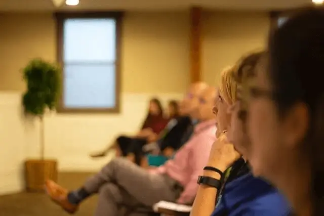 A small group of people listen intently to a lecture.